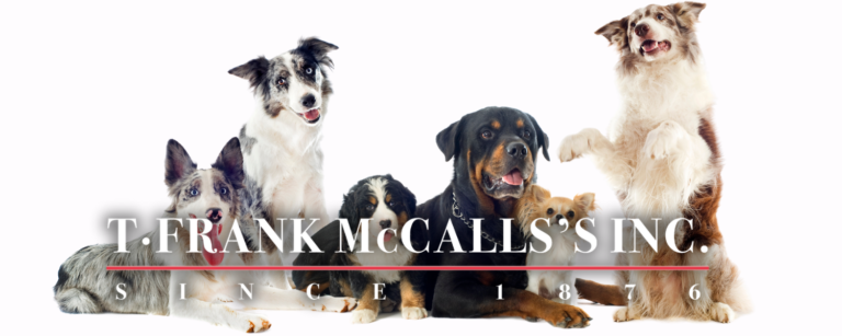T Frank McCalls logo over top of a group of dogs (white background)