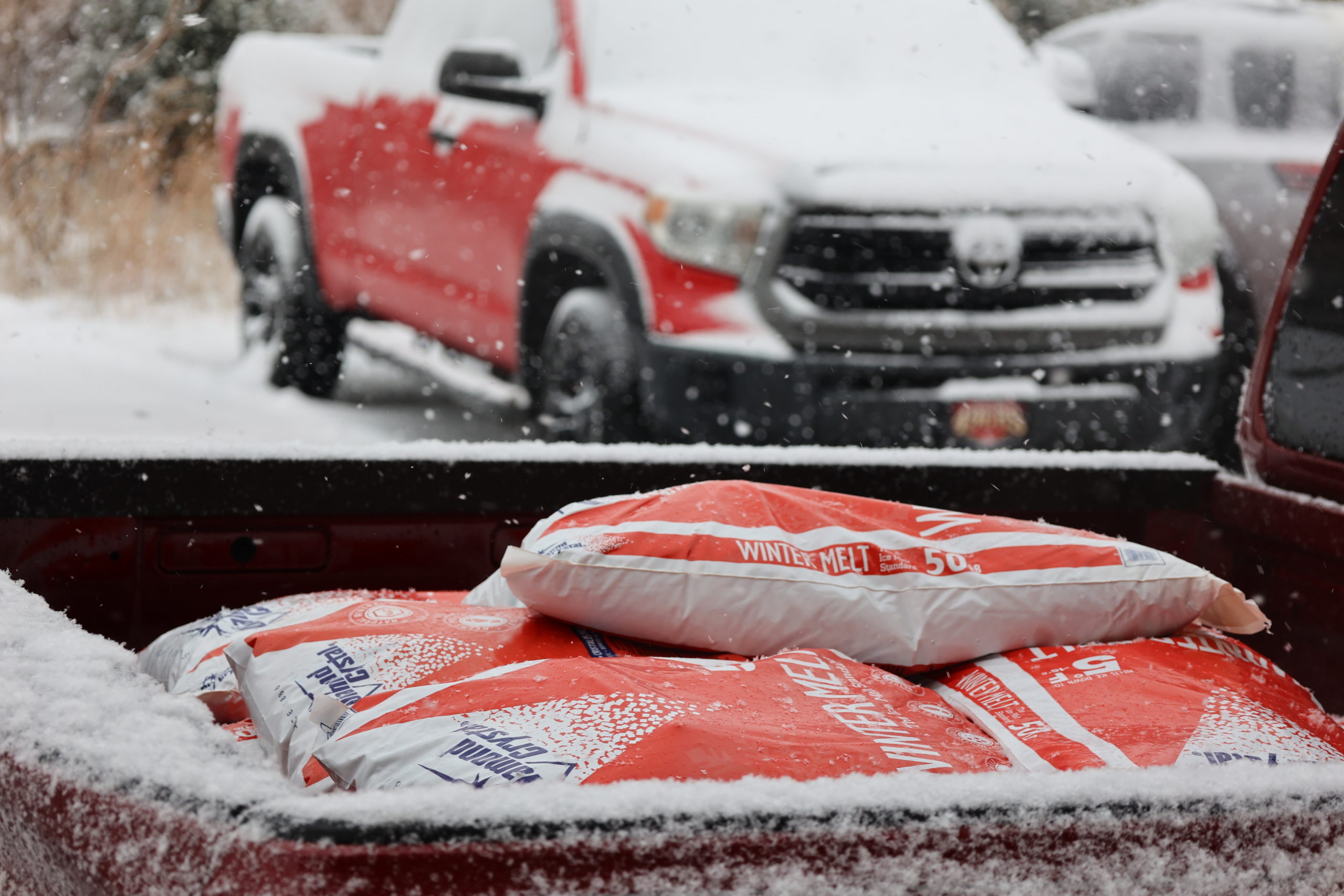 ice melt pallets in a red truck bed